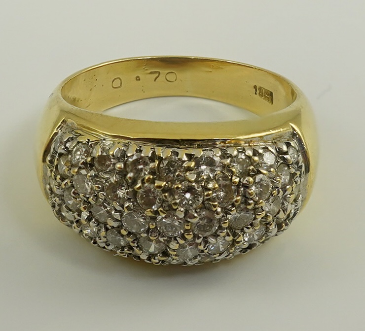 A modern 18k gold and diamond cluster set domed ring